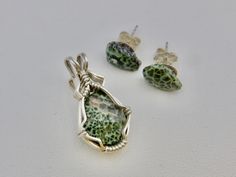 "This is an Isle Royale Greenstone Pendant set in argentium silver wires. If you have been seeking a Greenstone from Isle Royale, here is a beautiful Isle Royale stone necklace.   This Isle Royale Greenstone has a nice sage green color, alligator pattern and small streak of Thomsonite inclusions, characteristic of Isle Royale stones.  A 18\" sterling silver chain is available at checkout. The earrings are a good match to the stone color, a light green with a couple bits of pink. Small enough to Green Sterling Silver Wire Wrapped Jewelry, Green Wire Wrapped Sterling Silver Jewelry, Wire Wrapped Green Sterling Silver Jewelry, Green Sterling Silver Gemstones For Jewelry Making, Isle Royale, Alligator Pattern, Silver Sage, Sage Green Color, Argentium Silver