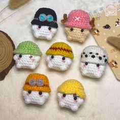 small crocheted hats are displayed on a table