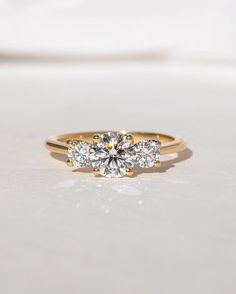 three stone engagement ring in yellow gold