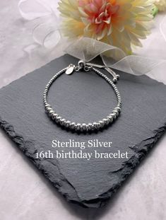 *ITEM DESCRIPTION* This lovely beaded bracelet is made using 2mm sterling silver beads and 16 tube beads which represent 16 years.  This bracelet is also available in 18 and 21 years but can be made with any number of tube beads on request 18th birthday bracelet here https://etsy.me/2t7MoYr  21st birthday bracelet here https://etsy.me/2t8Cequ  There is a choice of silver or rose gold vermeil for the tube beads and can be mixed and matched.  The beads are threaded on to the highest quality beadin Silver Sterling Beaded Bracelets For Birthday, Adjustable Sterling Silver Bracelet For Birthday, Anniversary Silver Beaded Bracelets, Silver Bracelets With Round Beads For Birthday, Silver Hypoallergenic Beaded Bracelets For Birthday, Silver Beaded Bracelets For Mother's Day And Birthday Gifts, Personalized Silver Beaded Bracelets For Birthday, Sterling Silver Bracelet With Spacer Beads For Gift, Hypoallergenic Beaded Bracelets For Anniversary