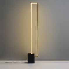 a lamp that is sitting on top of a table next to a white wall and floor