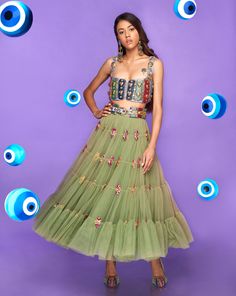 A tiered tulle half Lehenga in moss green embellished with glass stones and metal pieces. Paired with an original Papa Don't Preach tab bralette in lilac embellished with glass cut beads.From Papa Don’t Preach’s Nazar Na Lage collection. DELIVERY TIMEPlease allow 8-12 weeks for your outfit to arrive. FABRIC DETAILSTulle. Professional cleaning only. Organza Tiered Skirt Lehenga For Party, Organza Tiered Lehenga For Party, Organza Lehenga With Tiered Skirt For Party, Glamorous Green Embellished Choli, Glamorous Green Choli With Mirror Work, Green Hand Embellished Lehenga For Party, Glamorous Green Choli For Festive Season, Glamorous Green Choli For Festive Occasions, Glamorous Green Lehenga For Reception