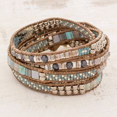 Turquoise and Beige Glass Beaded Wrap Bracelet Bohemian Multi-strand Beaded Bracelets With Silver Beads, Artisan Blue Beaded Bracelets For Beach, Beaded Brown Wrap Bracelet For Beach, Brown Beaded Wrap Bracelet For Beach, Beaded Brown Wrap Bracelet For The Beach, Artisan Blue Bracelets For The Beach, Turquoise Beaded Bohemian Wrap Bracelet, Brown Beaded Friendship Bracelets For Beach, Beaded Brown Friendship Bracelets For Beach