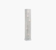 a tall white lamp with some lights on it