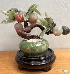 a small bonsai tree is sitting on a table