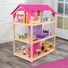 a wooden doll house with furniture and accessories