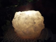 a white light sitting on top of a doily