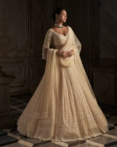 This lehenga set features tonal embroidery in pearl, sequin and crystal on a warm cream base. The blouse has elbow length sleeves with exaggerated pearl tassels. The four sided embroidered dupatta has pearl tassels as well.From Seema Gujral's Inara collection. DELIVERY TIMEPlease allow 8-12 weeks for your outfit to arrive. FABRIC DETAILSNet Professional cleaning only. Pearl Lehenga, Pearl Tassels, Seema Gujral, Pakistani Bridal Dress, Wedding Lehenga Designs, White Indian Wedding, Cream Base, Wedding Reception Dress, Pearl Cream