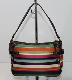 This colorful Coach tote bag measures approximately 6” x 10” x 4”. This is a used bag with minimal wear and minor staining on the front. Please closely inspect all photos before purchasing. Closure: Zip Strap Drop: 6” Color: Multi-Color Pockets: 1 Interior & 1 Exterior Material: Nylon Style: Tote Bag Photos are Actual pictures, not stock photos. Authenticity Note: We have been trained to spot fake designer bags, and closely inspect each purse to verify authenticity. If we have any doubts, we NEV Multicolor Coach Pouch Bag, Green Coach Shoulder Bag With Top Carry Handle, Multicolor Rectangular Coach Shoulder Bag, Coach Multicolor Rectangular Bag, Coach Multicolor Everyday Bag, Coach Multicolor Shoulder Bag For Everyday, Multicolor Rectangular Coach Bags, Multicolor Retro Coach Bag, Multicolor Coach Bag With Zipper Closure