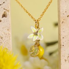 The Lemon Quartz Necklace dazzles with its citrusy charm, featuring a radiant gemstone that captures the essence of sunshine and brings a bright, joyful touch to any attire. The Lemon Flower Necklace is a radiant treasure, featuring a brilliant lemon quartz gem that exudes vibrancy. Encased in a sleek setting of silver with an 18K gold finish, this necklace is a burst of sunshine around your neck, perfect for brightening any day and adding a cheerful sparkle to your favorite outfits. DETAILS Plating: 18K Gold Materials: 18K Gold on Brass, Enamel, Cubic Zirconia, Pearl Measurements: Length: 16.14"(41cm) + Extender: 1.97"(5cm) Pendant Size: 1.89"*1.02"(4.8cm*2.6cm) Weight: 9.2g Yellow Gold Enamel Jewelry With Flower Charm, Yellow Enamel Jewelry With Charms, Yellow Gold Flower Charm Necklaces, Yellow Gold Flower-shaped Necklaces With Charms, Yellow Gold Flower Necklaces With Charms, Yellow Gold Flower-shaped Necklace With Charms, Yellow Enamel Flower Shaped Jewelry, Elegant Yellow Jewelry With Flower Charm, Elegant Yellow Jewelry With Charms