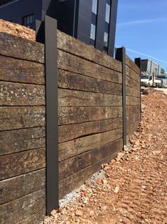 a wooden fence with metal posts on the side