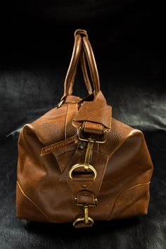 Travel in style with the beautifully hand made Full Grain Leather Overnight Bag. This dashing duffle is cabin-approved for air travel and the soft, sturdy leather can be stuffed into an overhead bin with ease. The durable crazy horse leather and chic styling make this duffle bag ideal for work or play. The interior boasts open pockets that are ideal for storing cash, cards, or keys, plus a large zip pocket, make staying organized a breeze. The roomy interior is spacious enough to hold clothing a Leather Overnight Bag, Travel In Style, Air Travel, Crazy Horse, Overnight Bag, Travel Companion, Staying Organized, Natural Leather, Travel Style