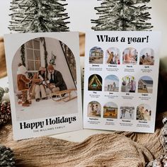 two christmas cards sitting on top of a table next to pine cones and fir trees