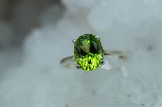 This is a beautiful Peridot from Pakistan set in Sterling Silver. This amazing stone has the perfect lime green color that many want with a great luster, and clarity!. Peridot is one of those underrated stones that has a quite remarkable history. Peridot is August's Birthstone. This nicely sized 9mm X 7mm Oval Peridot weighs 2.220cts and will go great with most styles or occasions. They will even go good with some of our Peridot Earrings located in our Gemstone Stud Earring Section. Please feel Verde Lima, Peridot Earrings, Gemstone Stud Earrings, Gem Ring, Peridot Ring, Gemstone Studs, August Birth Stone, Stud Earring, Gemstone Pendant