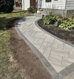 a brick walkway in front of a house