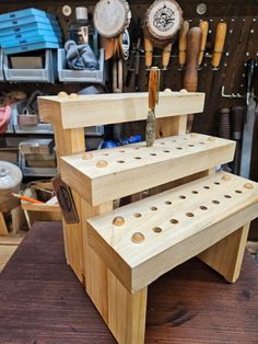 a wooden bench made out of three pieces of wood with holes in the bottom and sides