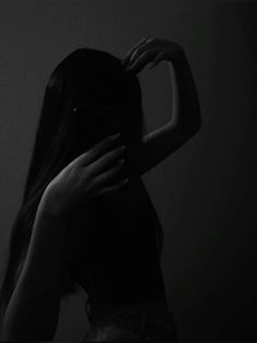 black and white photograph of a woman's back with her hands behind her head