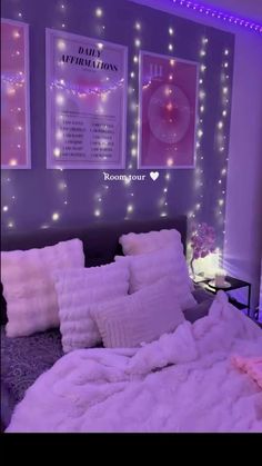 a bed room with a neatly made bed and some lights on the wall above it