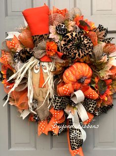 an orange and black wreath with leopard print, cheetah, and pumpkins