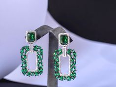 Colombian emerald pendant earrings, 925 silver, nickel free, premium quality cubic zirconia. Stone color vivid green. MADE IN ITALY Colombian emerald earrings studded with high quality diamonds. Elegant, minimal, exotic and sparkling design! DETAILS * Length: 43 mm * Width: 20 mm * Made of 925 sterling silver * MADE IN ITALY * Post-Closure * Sold in pairs * Hypoallergenic and nickel free * Highest quality CZ stones MORE INFO * All items are well packaged in elegant jewelry boxes, ready for gifting. * Do you have questions? Do not hesitate to contact us :) Green Diamond Drop Earrings For Party, Green Cubic Zirconia Earrings With Prong Setting, Green Cubic Zirconia Diamond Drop Earrings, Emerald Cut Green Sterling Silver Earrings, Luxury Green Cubic Zirconia Earrings, Green Prong-set Dangle Earrings, Earrings Emerald, Emerald Earrings Studs, Colombian Emeralds