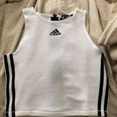 Adidas White And Black High Neck Zippered Sports Tank. Size Small. Brand New. Never Worn. Cute For An Athleisure Look. No Padding. Has Ribbing In Material. Sporty Spring Activewear With Side Stripes, Sporty Cotton Tank Top, White Cotton Sporty Tank Top, Adidas White Activewear With Three Stripes, Adidas Sporty Sleeveless Tank Top, Sporty Crew Neck Tank Top For Streetwear, Adidas Three Stripes Tops For Gym, White Activewear With Side Stripes For Workout, White Spring Activewear With Three Stripes Branding