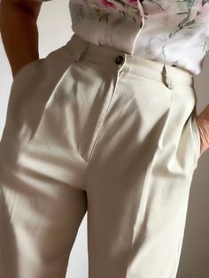 "Quality Vintage 80s Highrise classic pleated pants in a light beige tone.  Pleated front, two deep side pockets and attached back pocket. Bootcut style. Fastens with button and front zipper. Perfect with your favorite heels or flats. Or as shown in the picture, with your favorite boots. Classy and sophisticated vintage trousers that will never go out of style.  Best fits M depending on desired drape. Tag reads 100% cotton, Size 12L, Made in USA. Please refer to measurements.  Shown in 5'8\", 38 Classic Pleated Summer Pants, Summer Classic Pleated Pants, Classic Summer Pleated Pants, Cream Trousers For Business Casual, Chic Pleated Beige Bottoms, Fitted Beige Pleated Bottoms, Tailored Cream Bottoms For Business Casual, Cream Tapered Leg Bottoms For Workwear, Classic Cream Tapered Leg Pants