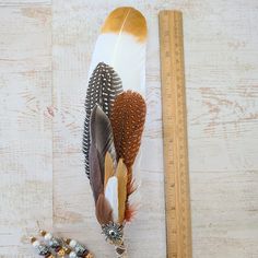 an image of some feathers and a ruler on a table with other things to sew