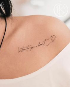 the back of a woman's shoulder with a tattoo that says, listen to your heart