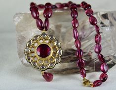 PRODUCT DETAILS TOTAL WEIGHT IS 257 CARAT NATURAL FINE QUALITY PINK TOURMALINE BEADS ALL NATURAL STONES LENGTH OF THE NECKLACE IS 16 INCHES DIMENSION OF THE PENDANT IS LENGTH-38MM / WIDTH-33MM / DEPTH-7MM DIMENSION OF THE PENDANT IS LENGTH-53MM / WIDTH-15MM / DEPTH-5MM SIZE OF THE BEADS ARE FROM 13MM TO 8MM MOST RARE UNIQUELY DESIGNED EXCLUSIVE ONE OF ITS KINDS BUY IT NOW NOTE - #You will receive the same product you see in picture. #DEAR ETSY BUYERS PLEASE FEEL FREE TO ASK QUESTIONS #WE WILL BE Temple Jewelry With Round Gemstone Pendant, Temple Jewelry With Gemstone Round Pendant, Yellow Gold Kundan Necklace With Gemstone, Yellow Gold Kundan Necklace With Gemstone For Gift, Yellow Gold Ruby Bead Jewelry, Kundan Necklace With Round Pendant For Gift, Spiritual Festive Jewelry With Faceted Beads, Spiritual Jewelry With Faceted Beads For Festive Occasions, Spiritual Faceted Beads Jewelry For Festive Occasions