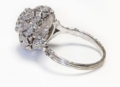 a diamond ring is shown on a white surface with the center stone surrounded by smaller diamonds