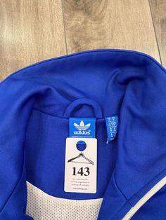 Description: Adidas full zip sweatshirt Flaws: Light pilling on back and left sleeve that can be removed, please see pictures. Size: Small Length: 23" Pit to Pit: 17" Sleeve: 22.5" Brand: Adidas Era: 2010s Color: Blue Store Item #IN143 Adidas Long Sleeve Track Jacket With Three Stripes, Blue Long Sleeve Track Jacket For Sports Events, Blue Long Sleeve Track Jacket For Sports, Blue Half-zip Sweatshirt For Sports, Adidas Long Sleeve Sweatshirt For Sports, Three Stripes Branding Long Sleeve Sweatshirt For Sports Events, Long Sleeve Sweatshirt With Three Stripes For Sports, Adidas Half-zip Sports Top, Adidas Blue Track Jacket With Three Stripes