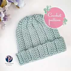 a crochet pattern for a beanie hat is shown next to some flowers