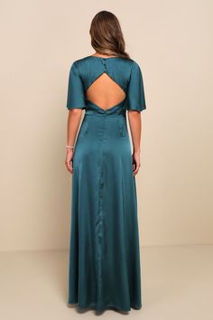 the back of a woman wearing a teal dress