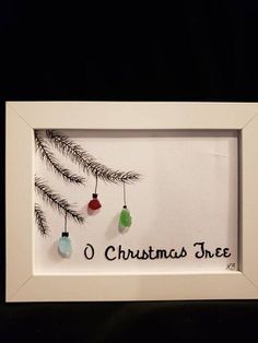 a white frame with christmas ornaments hanging from it's sides and the words o christmas tree