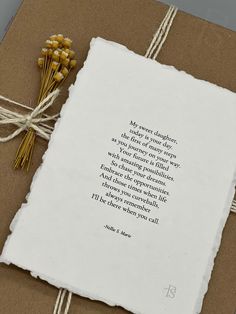 a piece of paper tied to a brown box with a poem written on the front