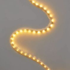 a long light strip with white lights on it's sides and an orange cord in the middle