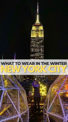 the empire building in new york city at night with text overlay that reads, what to wear in the winter in new york city