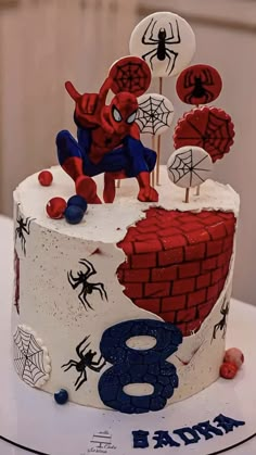 a spiderman themed birthday cake on a table