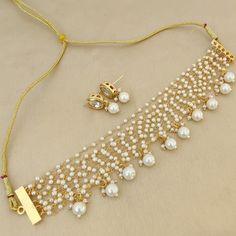 *Beautiful Premium Quality Kundan Choker With Pearls *Combination Of Kundan, Pearls *Quality Of Pearls Is Best *Comes With Matching Earrings *Front Side is Kundan With Pearls *Pearls And Kundan Are Of Original Quality *For More Beautiful Collection, Check At https://www.etsy.com/shop/placeoffashion *Necklace Fitting Is Adjustable *Earring Closure: Push Back **Necklace Closure : Beautiful Silk Thread *It is a Bridal or Partywear Set. *It Will Give You a Unique and Beautiful Look  *You Can Wear This Beautiful Set At Dress or Saaree  *The Colour Combination Of This Set Is Very Unique , It can go With Any Of The Outfit *It Gives You a Unique Look For Your Special Events Like Engagement, Mehandi, Haldi, Lady Sangeet, Wedding Or Any parties ( Marraige Anniversary) *It is a Perfect Gift for You L White Elegant Jewelry Sets For Party, White Bridal Earrings For Celebration With Elegant Design, White Dangle Bridal Necklace For Party, Gold Dangle Bridal Necklace For Wedding, White Dangle Bridal Necklace For Wedding, White Jewelry Sets With Pearl Chain For Celebration, White Pearl Drop Jewelry Sets For Wedding, Gold Pearl Bridal Sets As Gift, Pearl White Dangle Jewelry For Wedding