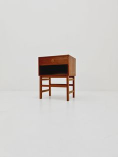 a small wooden table with a drawer on the top and one drawer at the bottom