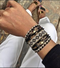 a close up of a person's arm wearing bracelets and sandals with gold stars on them