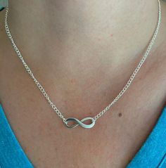 This is a simple yet beautiful infinity pendant necklace. The minimalist design is very versatile and may be worn with a variety of outfits. The infinity pendant symbolises everlasting love making it the perfect and special gift for an anniversary gift or valentines gift for that someone special.  The necklace is made with an elegant silver plated fine curb chain. In the centre of the chain there is a beautiful Tibetan silver infinity pendant which is 2.5 cm in length.  The necklace fastens by way of a lobster clasp and ring. The necklace exists in a variety of lengths. Longer lengths are not available in this design of necklace.  Lead and Nickle free The necklace comes wrapped and packaged in a gift box making that special and thoughtful gift.  Care of your necklace It is advised to clean Trendy Infinity Jewelry Gift, Trendy Infinity Jewelry For Gift, Adjustable Minimalist Infinity Necklace, Minimalist Infinity Necklace With Delicate Chain, Minimalist Adjustable Infinity Necklace, Minimalist Infinity Clavicle Chain Necklace, Minimalist Infinity Necklace For Everyday, Trendy Infinity Jewelry, Minimalist Sterling Silver Infinity Necklace