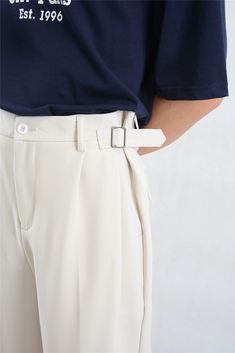 Make a statement with these Wide Leg Pleated Trousers, featuring a modern buckle detail for an elevated touch. 

Constructed with a focus on quality craftsmanship, these trousers boast a structured pleated design and are cut from a soft yet durable fabric blend. The relaxed silhouette is accentuated with clean lines, providing both style and comfort for day-to-night ensembles. 

Easily adaptable, they can be styled with a fitted turtleneck for professional settings or paired with a casual tee fo Chic Business Bottoms With Belt Loops, Formal Pants With Belt For Spring, Spring Formal Pants With Belt, Workwear Bottoms With Belt And Tapered Leg, Tapered Leg Workwear Bottoms With Belt, Classic Workwear Bottoms With Belt Detail, Formal Trousers With Belt, Formal High-waisted Pants With Belt, Modern Ankle-length Pants With Belt Loops