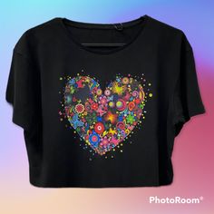 a black t - shirt with colorful flowers in the shape of a heart on it