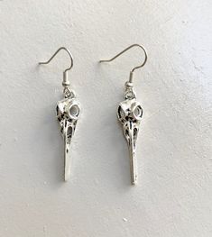 Bird skull witch earrings  These earrings are perfect for casual wear and they are bound to get noticed. They are also perfect as an addition to any costume. Materials: Charms: silver plated Earring hooks:steel Bird skull necklace: https://www.etsy.com/listing/1091926773/unisex-antiqued-silver-raven-skull?ref=shop_home_active_1&frs=1 QUESTIONS If you have any more questions, please send me a message via ETSY. Please visit all the items from my shop here: https://www.etsy.com/fr/shop/NewJewellery Silver Skull Earrings For Halloween, Skull-shaped Metal Earrings, Gothic Skull Metal Earrings, Steampunk Skull Jewelry For Halloween, Gothic Sterling Silver Skull Earrings, Metal Skull Single Earring, Edgy Nickel-free Skull Earrings, Edgy Adjustable Earrings For Halloween, Gothic Skull Earrings For Halloween