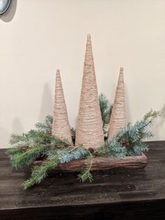 three christmas trees are sitting on a table