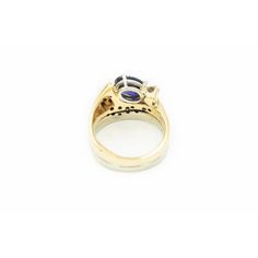 Very cool modernist stylized ring featuring a prong set oval tanzanite  (approximately 1.65 carats) which is accented by a single .15 carat (approximate weight) carat round full cut diamond and an additional 19 bead set diamonds.  The approximate total diamond weight for the piece is .50 carats.  The shank is yellow and white 14k gold.  there looks like there were hallmarks, but they have faded. Ring is is 7.25 US . Modern Oval Tanzanite Sapphire Ring, Modern Oval Sapphire Ring With Tension Setting, Modern Tanzanite Round Rings, Modern Oval Tanzanite Ring, Modern Tanzanite Rings, Modern Oval Sapphire Ring With Prong Setting, Timeless Oval Tanzanite Rings, Formal Oval Tanzanite Birthstone Ring, Oval Tanzanite Ring For Formal Occasions