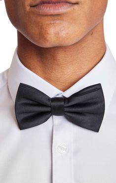 An updated version of the classic bowtie, the Bradley Bowtie in Satin Black makes an excellent addition to any formal outfit. The bowtie is pre-tied and adjustable, making it the perfect combination of convenience and elegance. PRODUCT DETAILS: style 6595B pre-tied bow tie adjustable band t-hook-to-fabric closure 100% polyester imported Classic Pre-tied Satin Bow Tie, Classic Pre-tied Bow Tie For Formal Occasions, Pre-tied Satin Bow For Black Tie Events, Classic Pre-tied Satin Bow, Classic Pre-tied Tie With Decorative Bow, Classic Pre-tied Bow Tie, Classic Pre-tied Bow With Ties, Classic Pre-tied Decorative Bow, Classic Pre-tied Bow