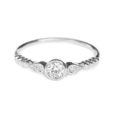 a white gold ring with three diamonds on it