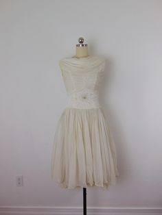 A darling vintage 50s dress with issues, sold as a costume due to flaws. There are holes on the shoulder and a couple on the skirt, it has been washed several times and the gray dinginess will not come out. Great Halloween costume! Will fit a small to XS best. length-40 bust-34 waist-24 hips-free Vintage Knee-length Dress For Costume Party, 1950s Style Vintage Dress For Summer Events, Vintage Sleeveless Dress For Costume Party, 1950s Tea Length Vintage Dress For Events, 1950s Tea Length Vintage Style Dress, Vintage Midi Dress With Fitted Bodice, Vintage Knee-length Wedding Dress, Vintage Tea-length Dresses, Sleeveless Vintage Cocktail Dress